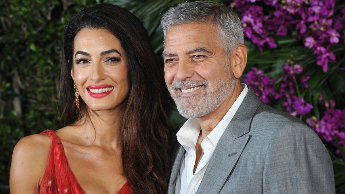 Amal and George Clooney smile for a photo