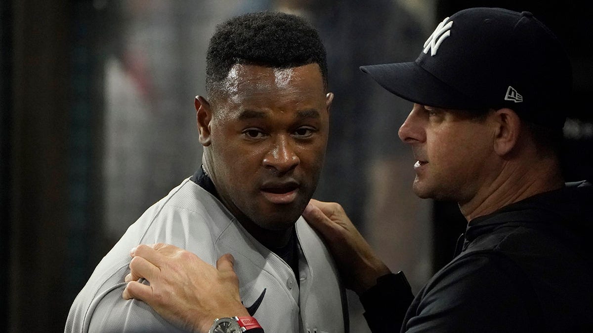 Pitcher Luis Severino in dugout with manager Aaron Boone