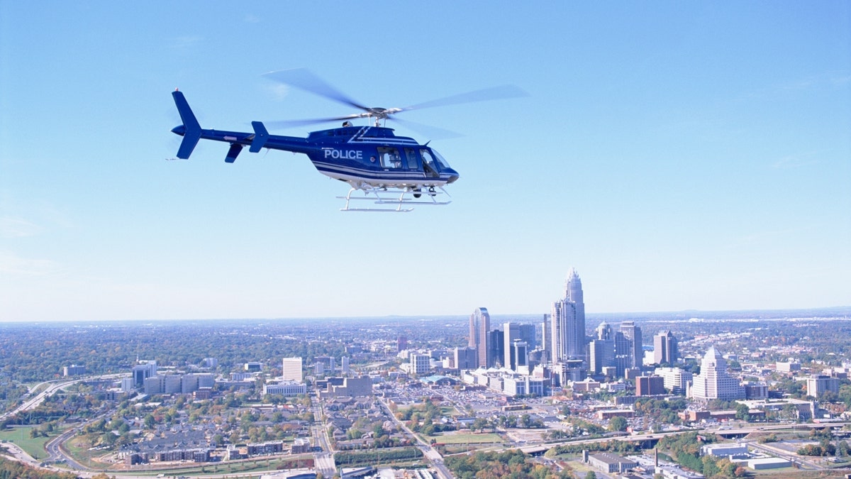 Charlotte police helicopter flying over city