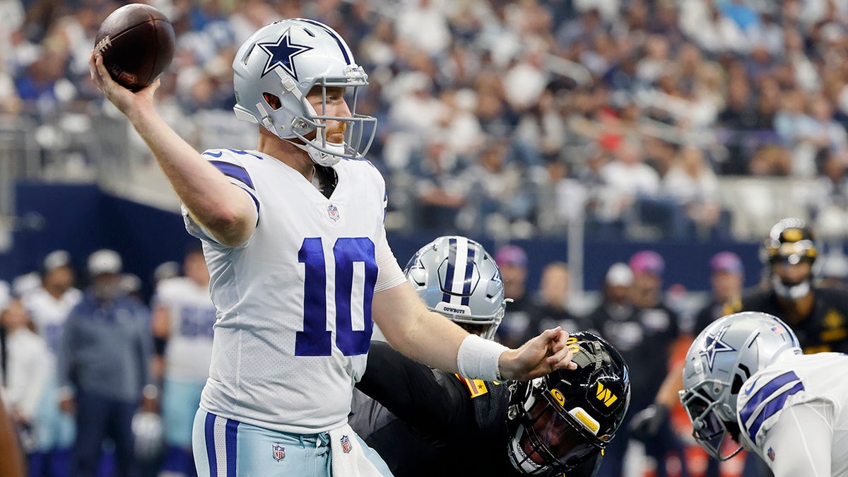 Cooper Rush throws a pass