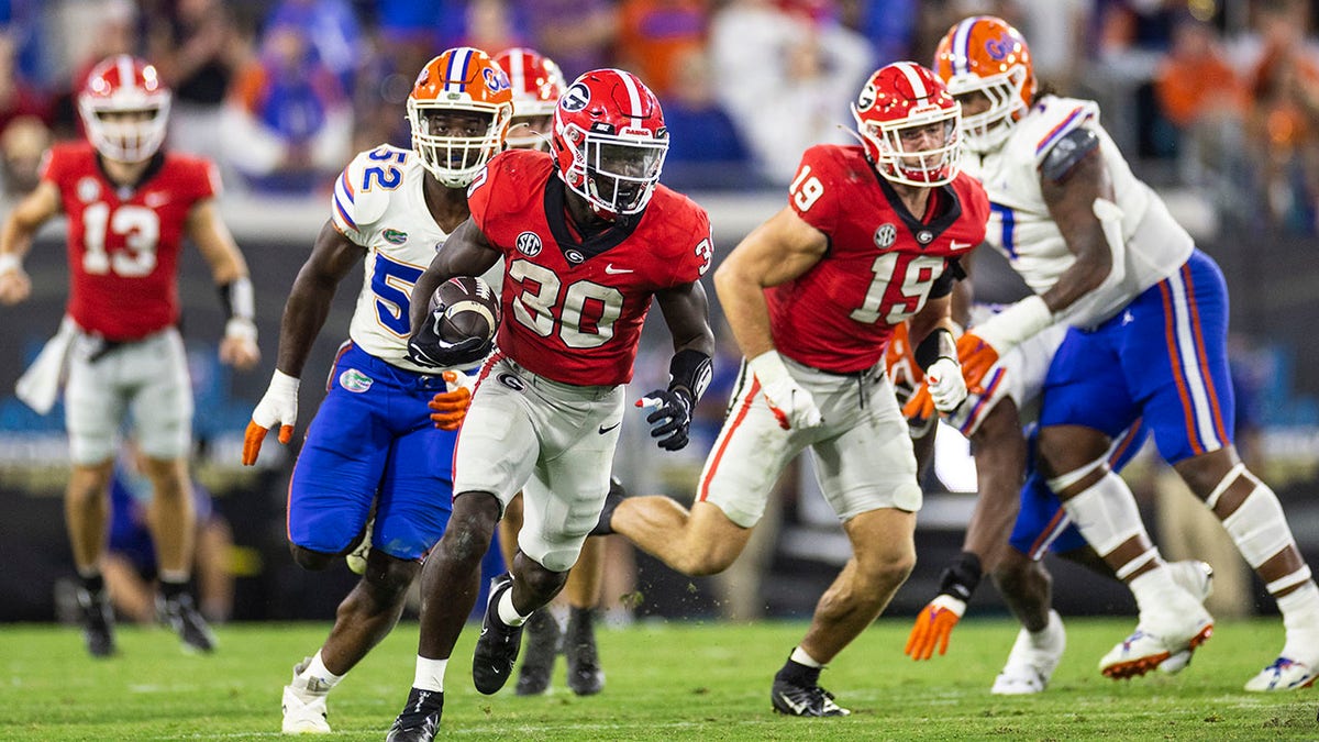 Georgia football player runs with the ball