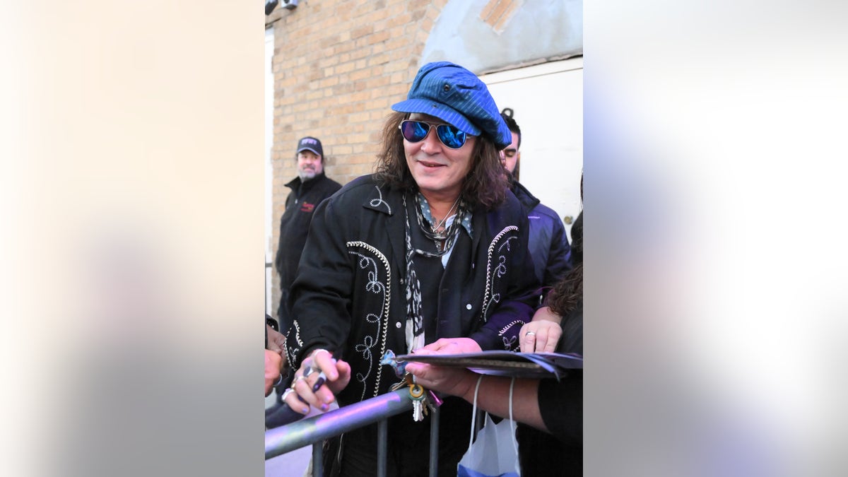 Johnny Depp smiles ahead of concert