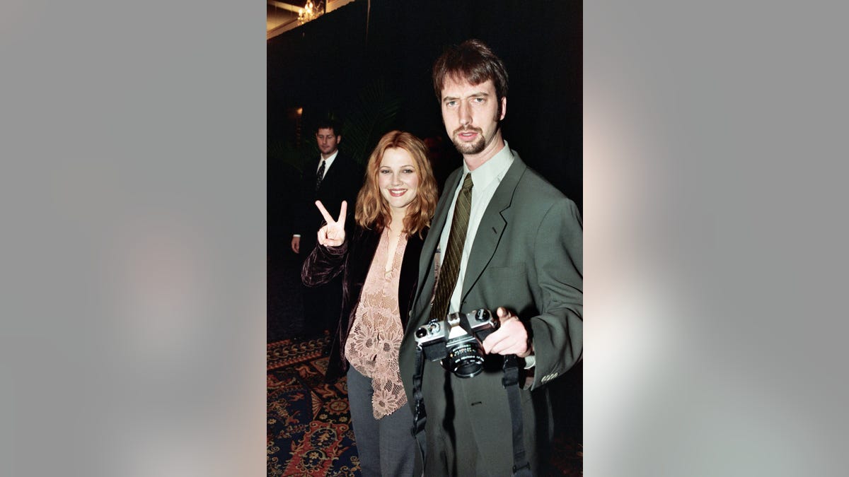 Drew Barrymore flashes peace sign with Tom Green