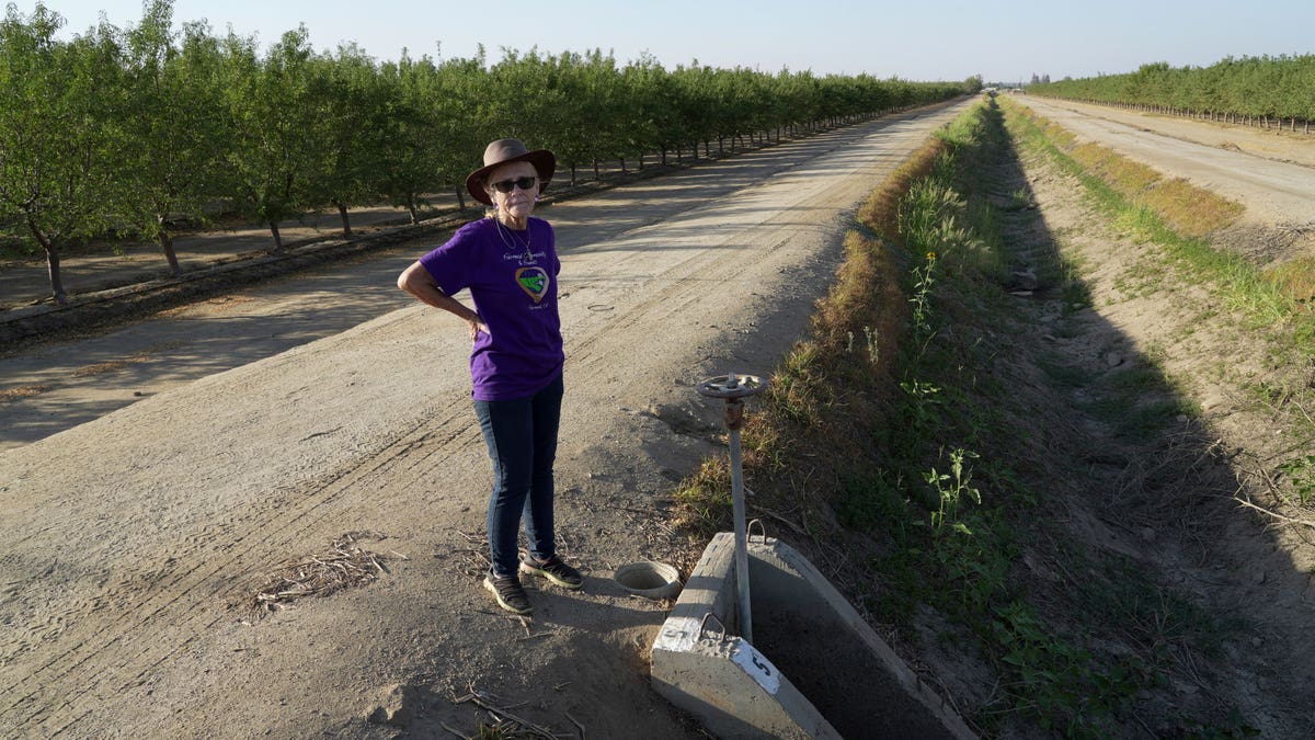 Woman standing next to a dry canal