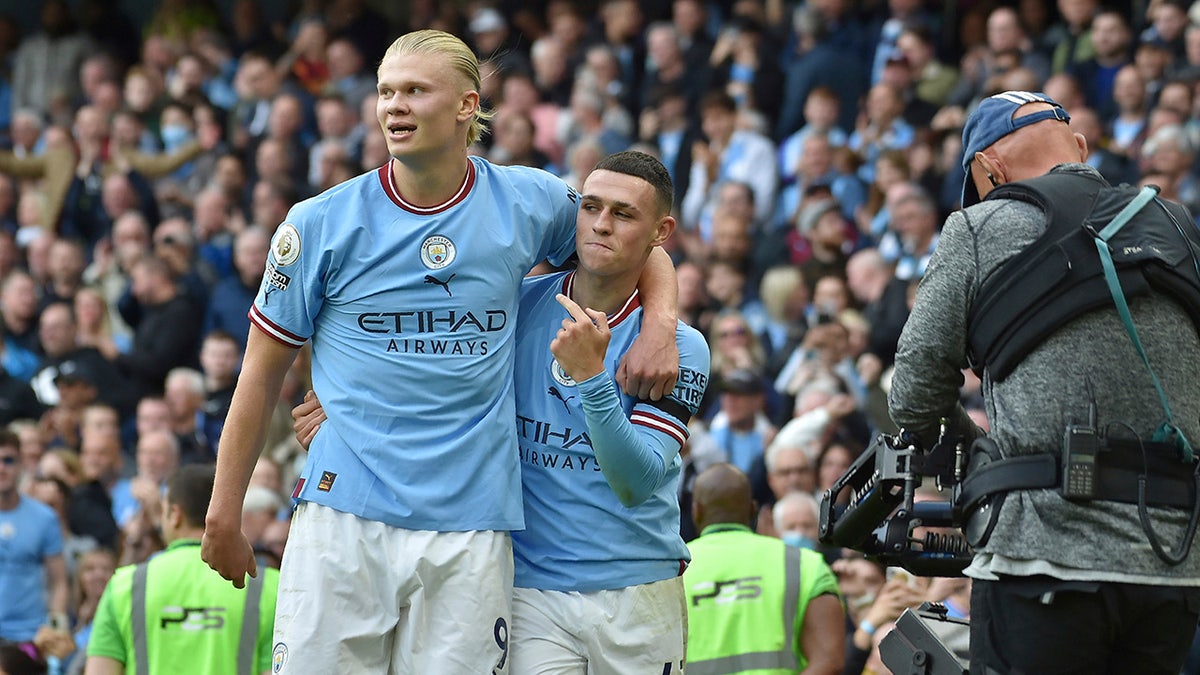 Erling Haaland with Phil Foden