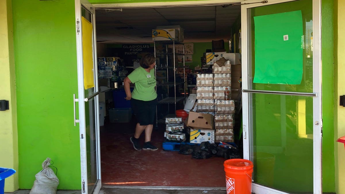 Woman standing in the building with donated food