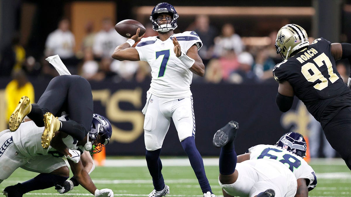 New Orleans Saints tight end Taysom Hill (7) carries for a first down  against Seattle Seahawks cornerback Tariq Woolen (27) during an NFL  football game in New Orleans, Sunday, Oct. 9, 2022.