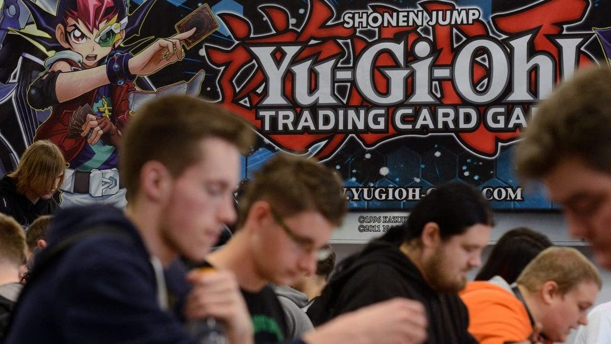 Various people competing at the Yu-Gi-Oh! Trading Card Competition