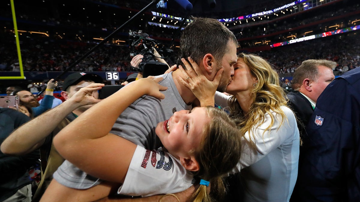 Tom Brady kisses his wife after winning his sixth Super Bowl