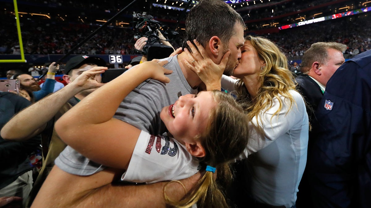 Tom Brady kisses his wife after winning his sixth Super Bowl