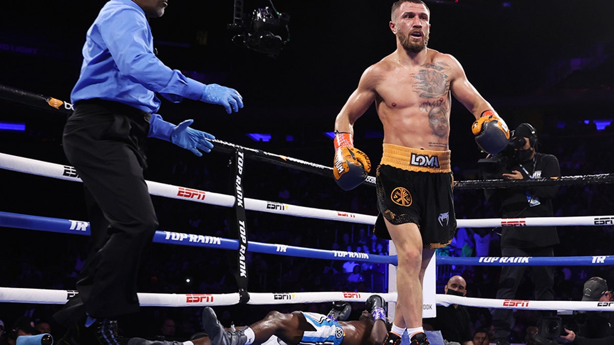 Vasiliy Lomachenko standing victorious over Richard Commey