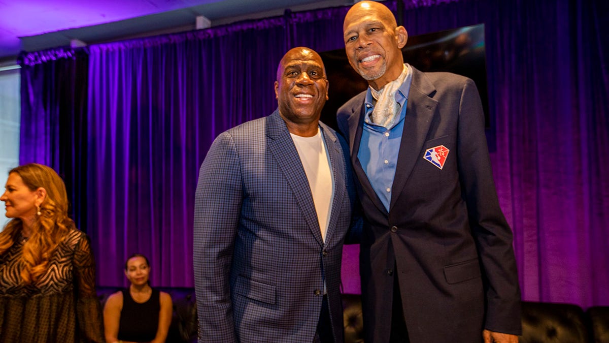Magic Johnson and Kareem Abdul-Jabbar pose for a picture