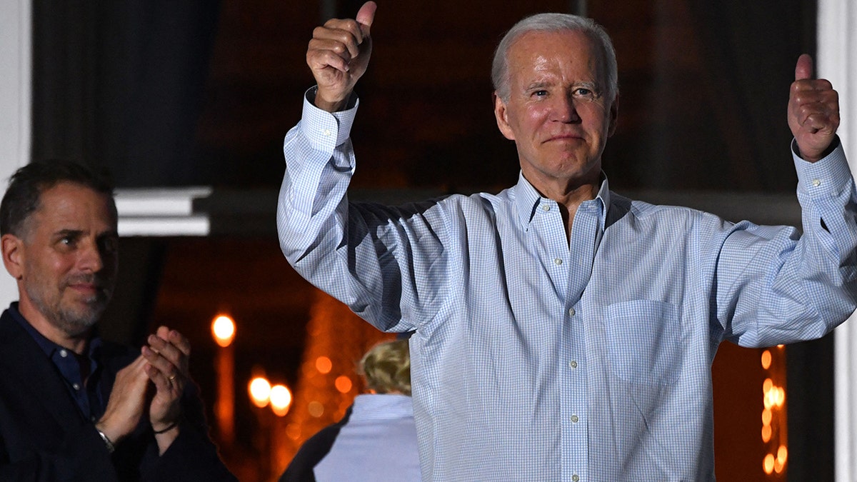 Joe Biden holding his thumbs up next to his son, Hunter