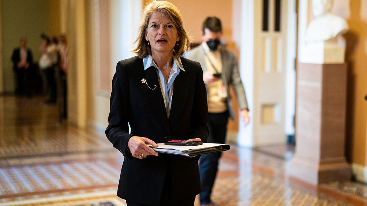 Lisa Murkowski walking down a hallway