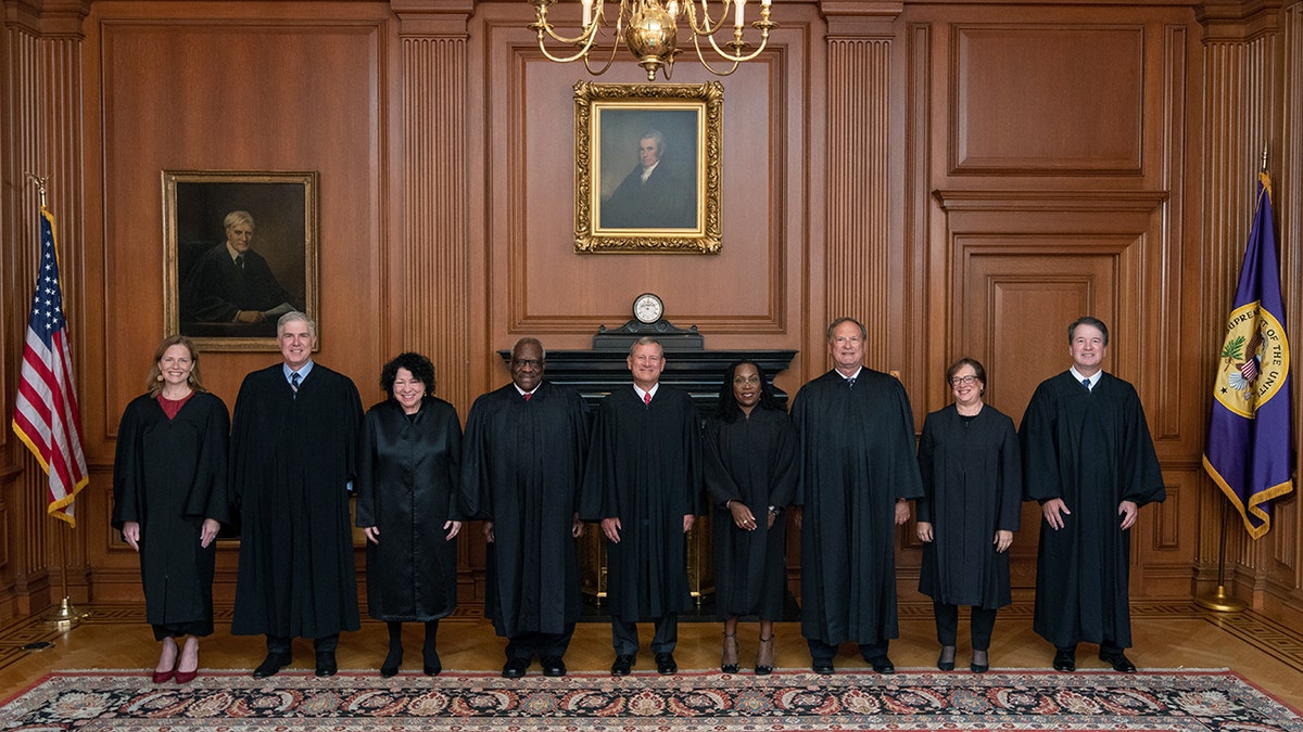 Supreme Court justices standing for photo