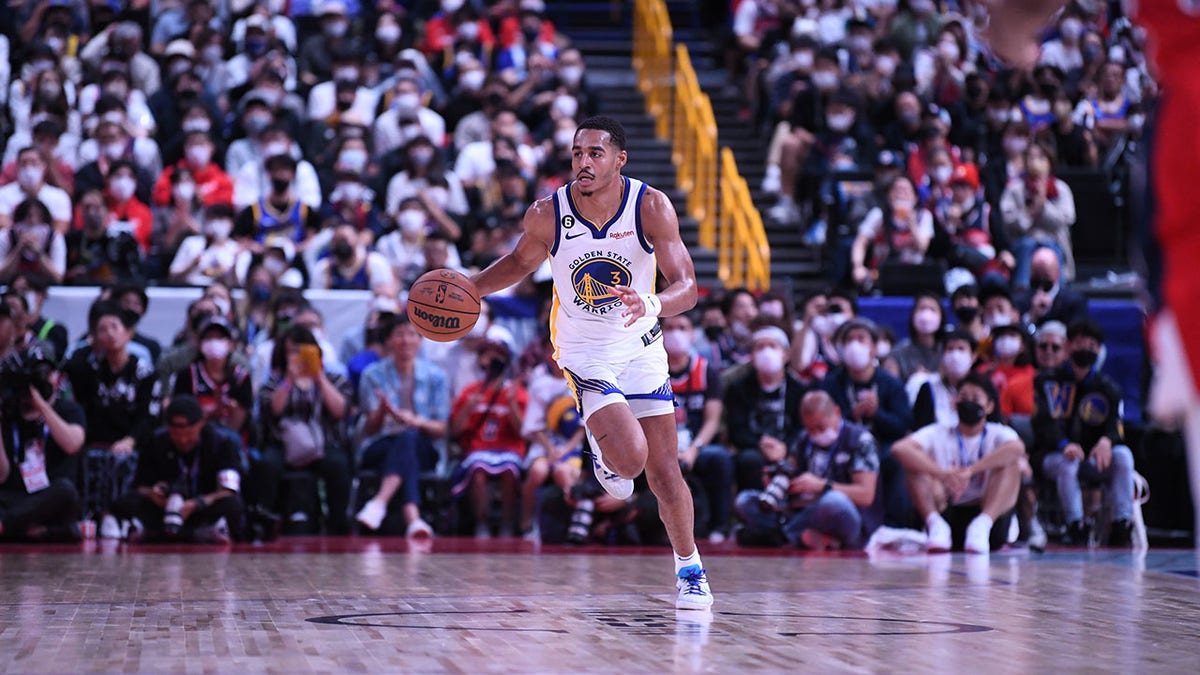 Jordan Poole plays in a preseason game in Japan