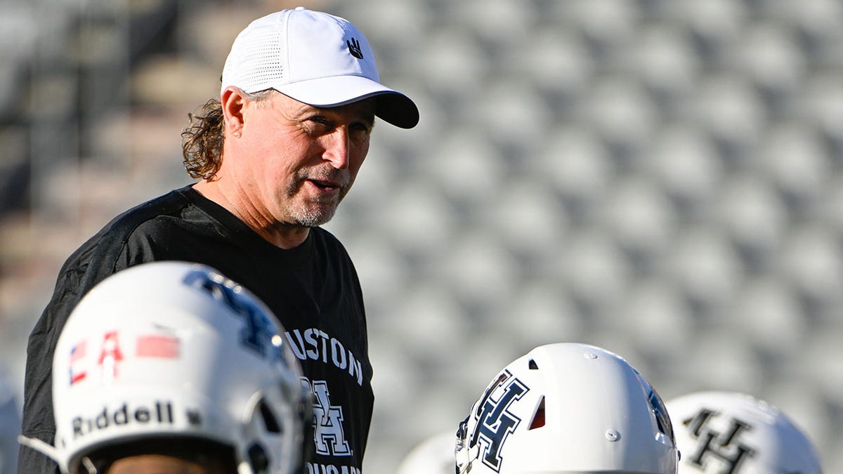 Dana Holgorsen talks with his players