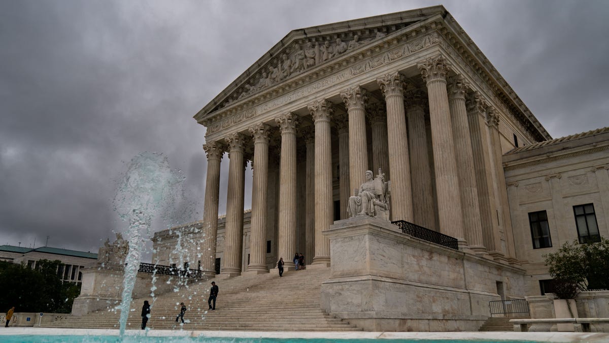 People walk up toward the Supreme Court