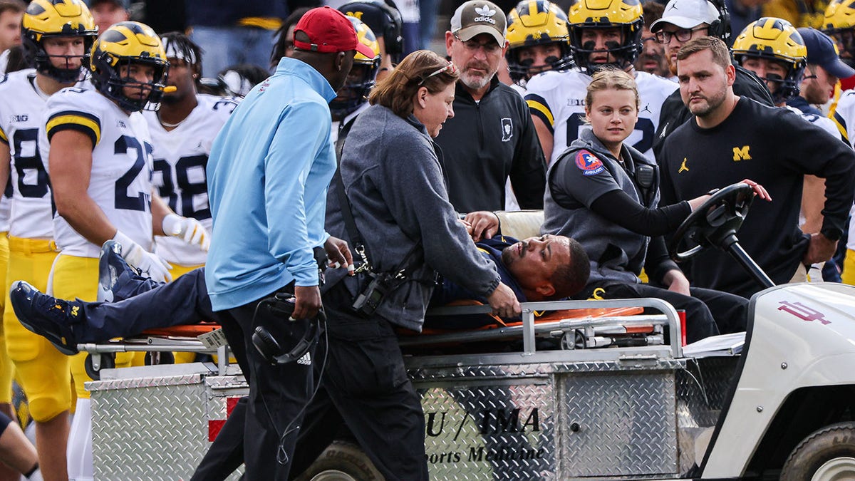Mike Hart is carted off the field during a Michigan game