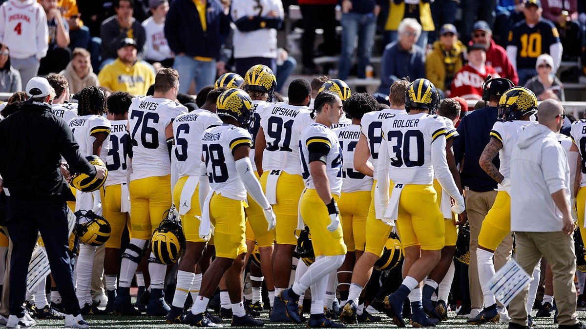 Michigan players gather around coach Mike Hart