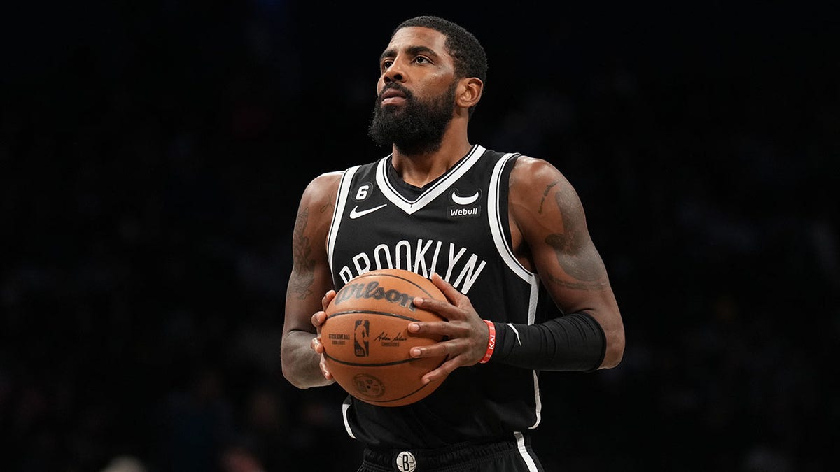 Kyrie Irving shoots a free throw against the Mavericks