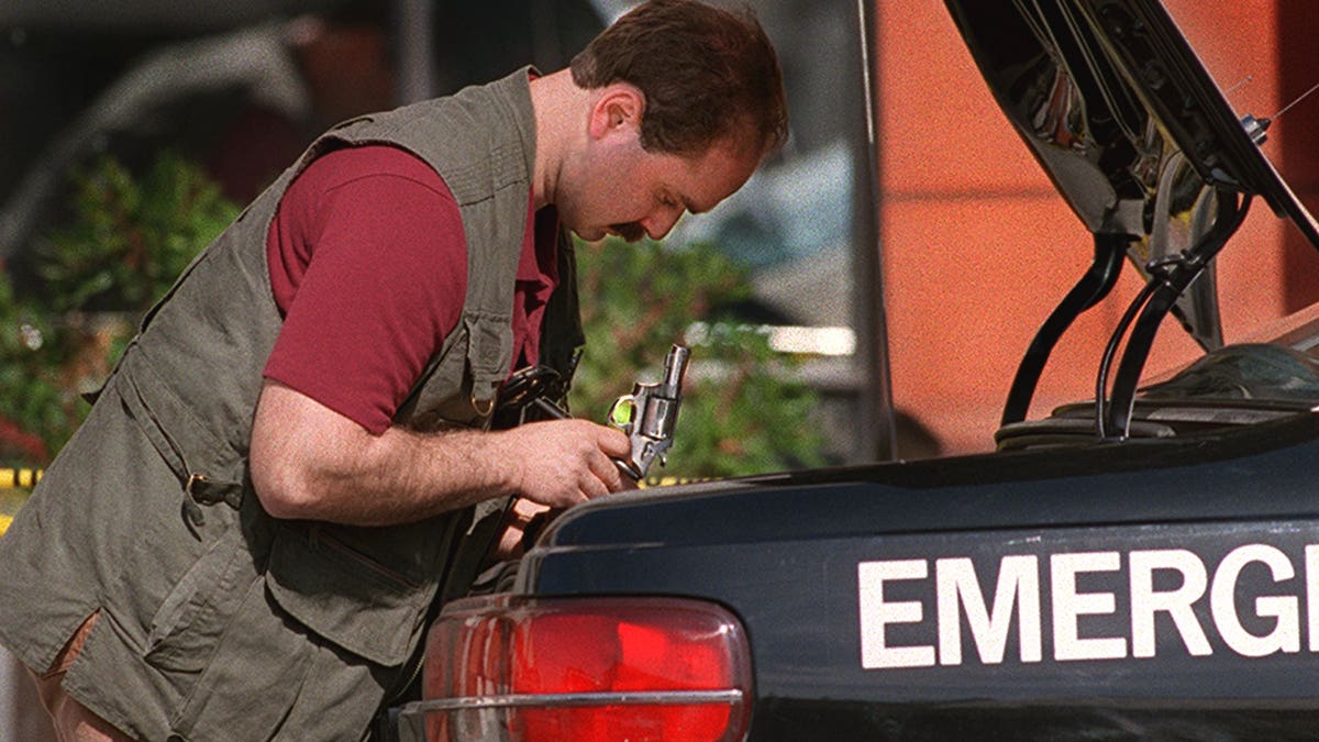 An investigator looking in a vehicle