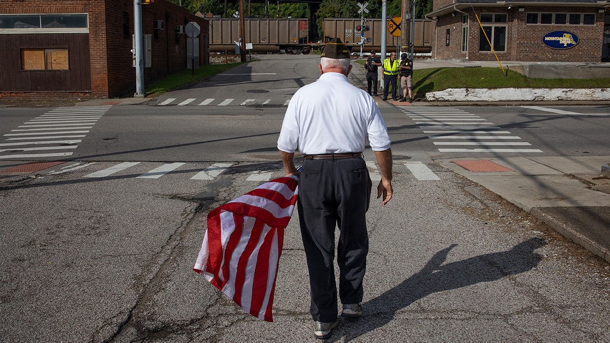 American Legion member holds flag