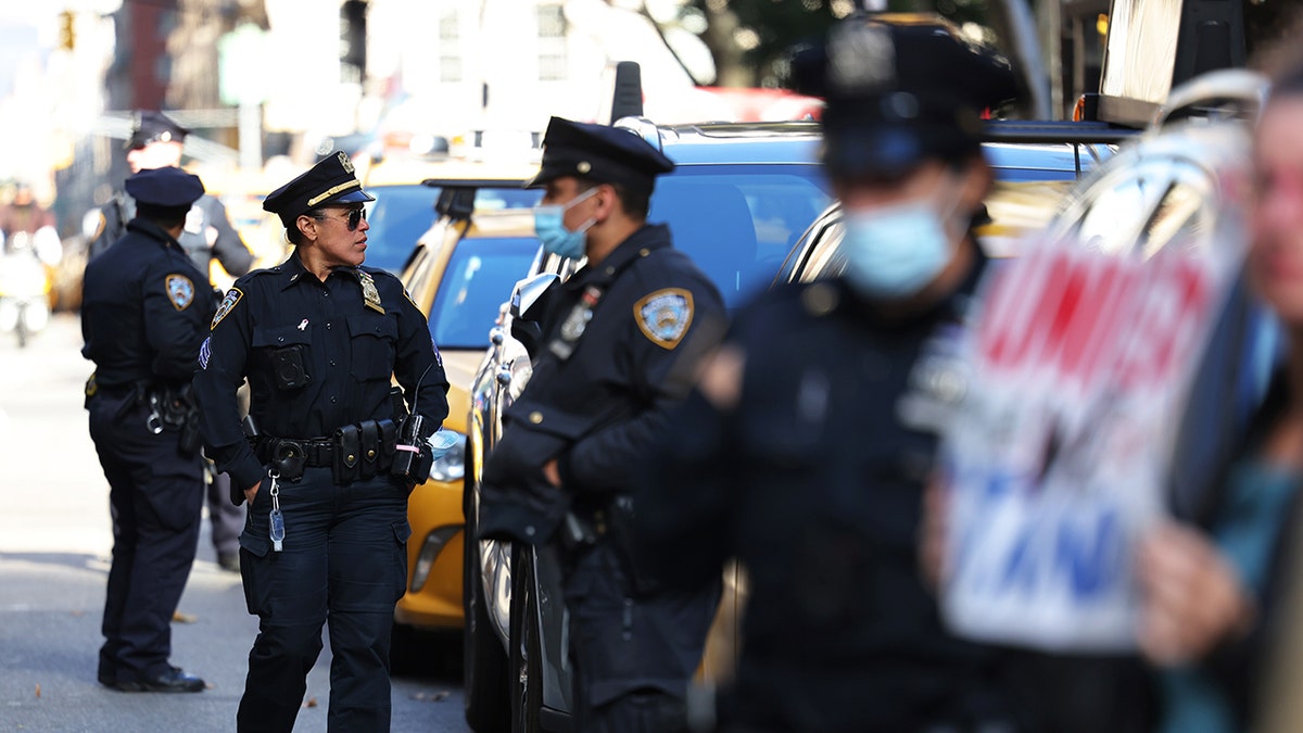 Des policiers montent la garde alors que les gens se rassemblent pour protester contre les mandats de vaccination pour les employés municipaux au City Hall Park le 3 novembre 2021 à New York. (Michael M. Santiago/Getty Images)