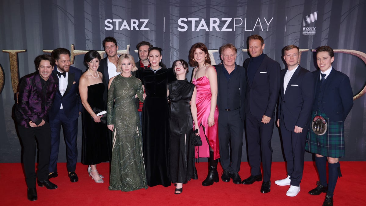 (L to R) Alexander Vlahos, Richard Rankin, Maril Davis, Cesar Domboy, Lauren Lyle, Steven Cree, Sophie Skelton, Jessica Reynolds, Caitlin O'Ryan, Mark Lewis Jones, Sam Heughan, Euan Bennet and Paul Gorman attend the "Outlander" Season Six Premiere at The Royal Festival Hall on Feb. 24, 2022 in London, England.