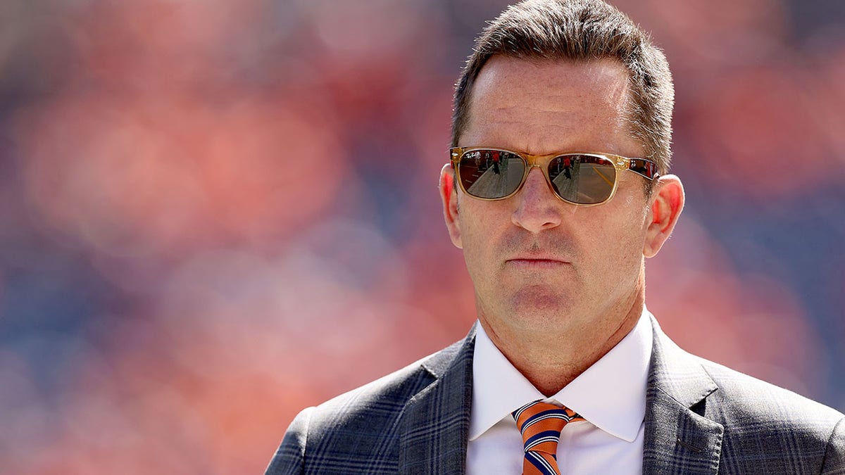 Broncos GM George Paton walks the field at Mile High