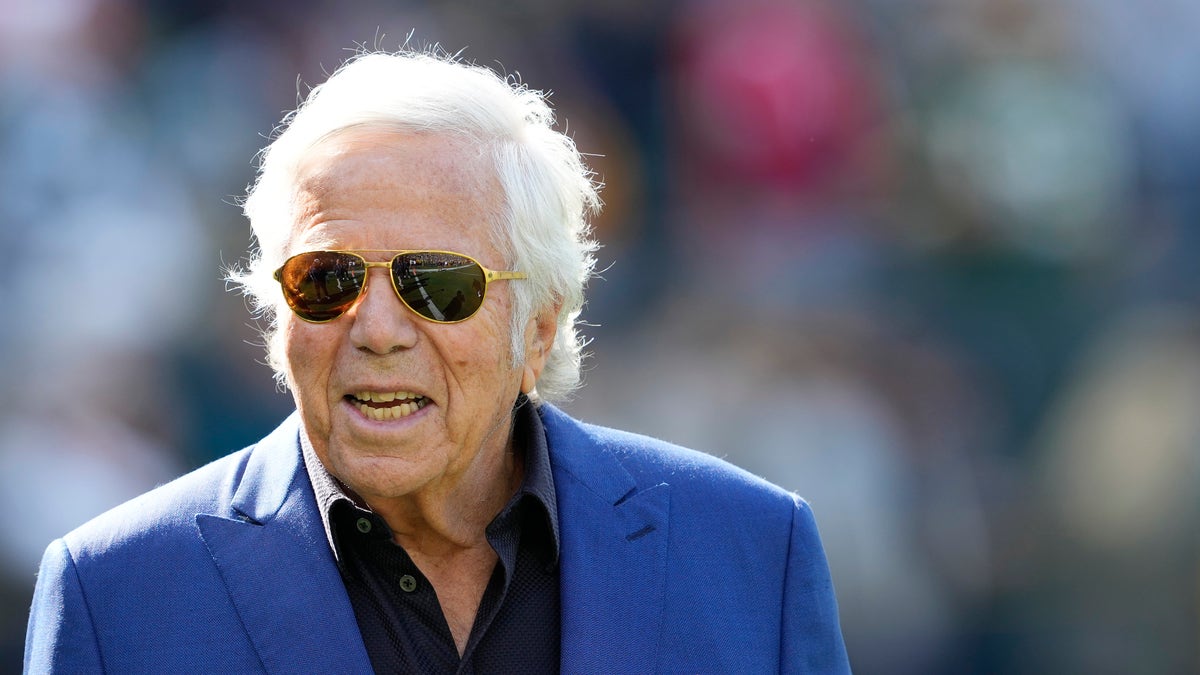 Patriots owner Robert Kraft stands on the field