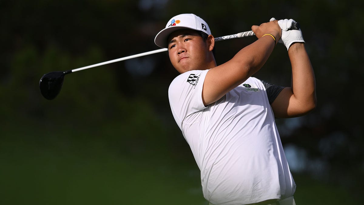 Tom Kim plays his shot on the 16th hole