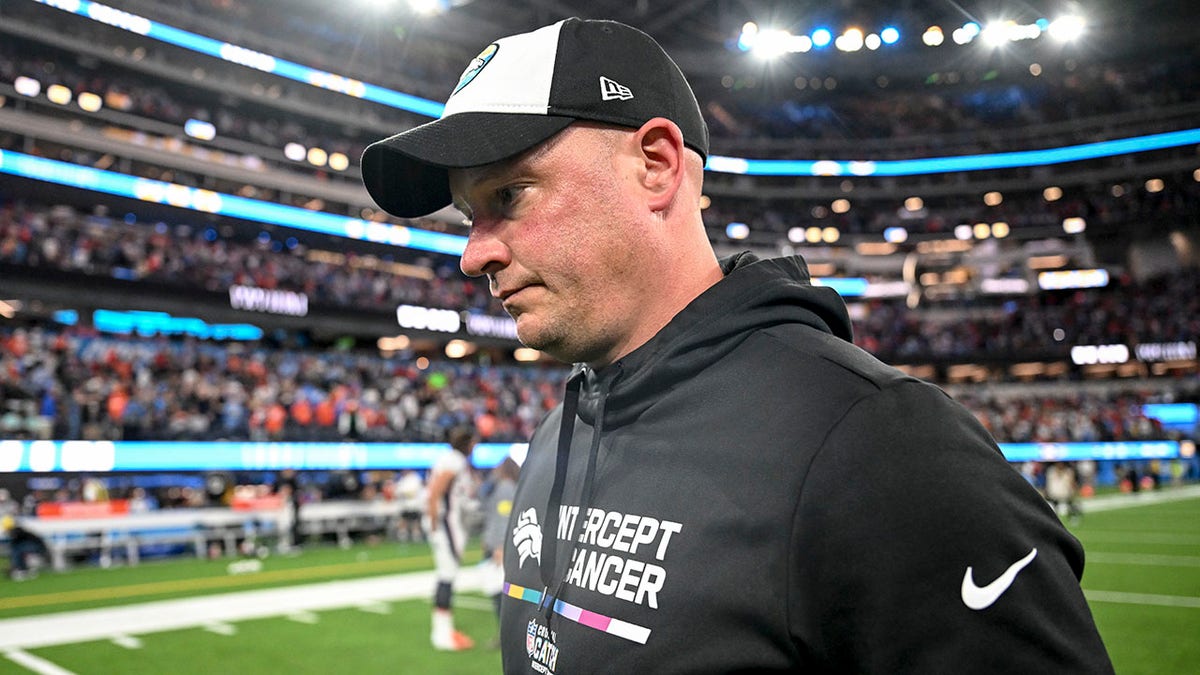 Nathaniel Hackett walks off the field after losing to the Chargers