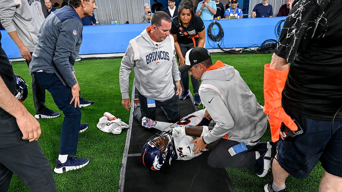 Aaron Patrick on the ground after colliding with sideline staffer