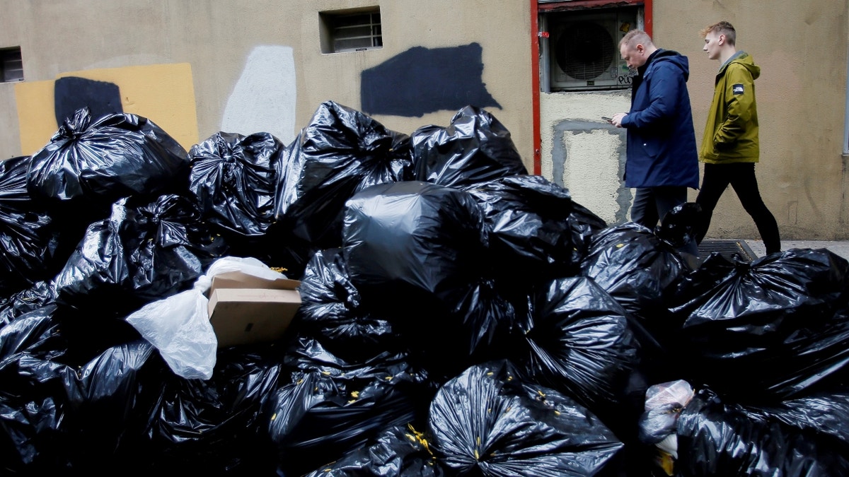 New Yorkers walking near trash