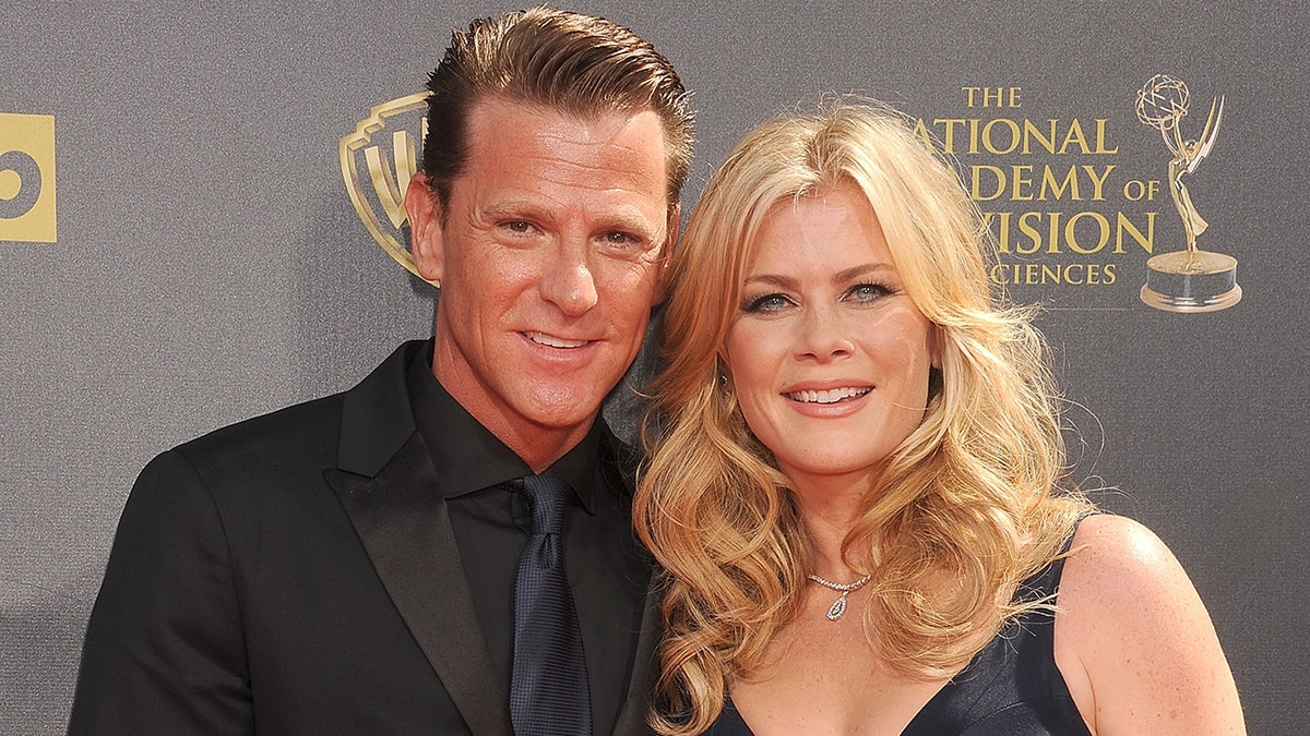 Alison Sweeney and her husband on the Emmys red carpet