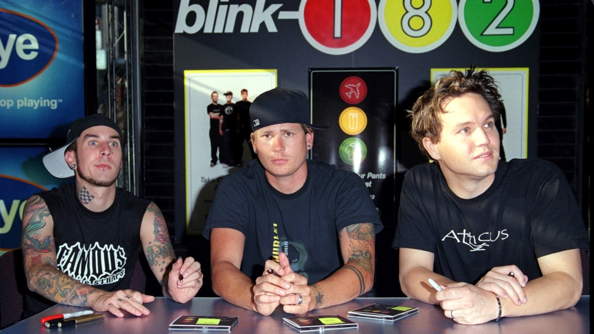 Travis Barker, Tom Delonge and Mark Hoppus seated together