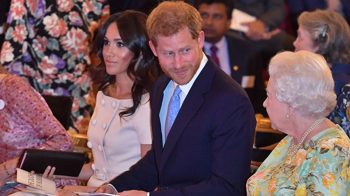 Queen Elizabeth II with Prince Harry, Duke of Sussex and Meghan, Duchess of Sussex at the Queen's Young Leaders Awards Ceremony at Buckingham Palace on June 26, 2018 in London, England. The Queen's Young Leaders Programme, now in its fourth and final year, celebrates the achievements of young people from across the Commonwealth working to improve the lives of people across a diverse range of issues including supporting people living with mental health problems, access to education, promoting gender equality, food scarcity and climate change. (Photo by John Stillwell - WPA Pool/Getty Images)