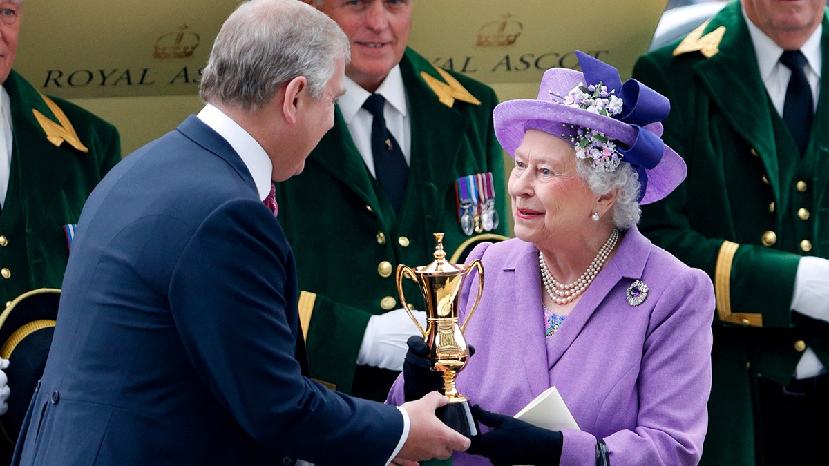 Prince Andrew, Duke of York presents his mother Queen Elizabeth II with the Ascot Gold Cup