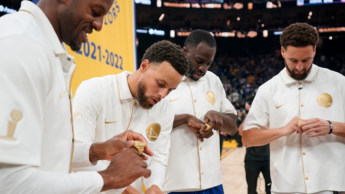 Golden State Warriors players admire their championship rings