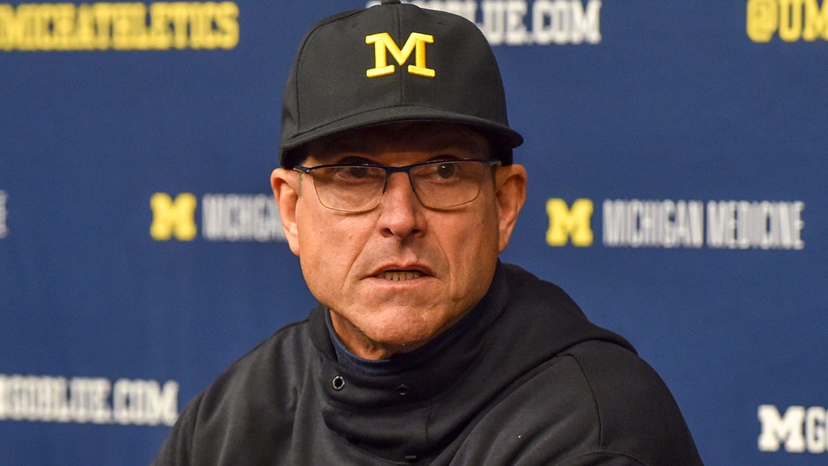 Jim Harbaugh talks to the media