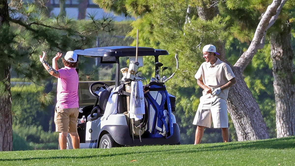 Justin Bieber by a golf cart