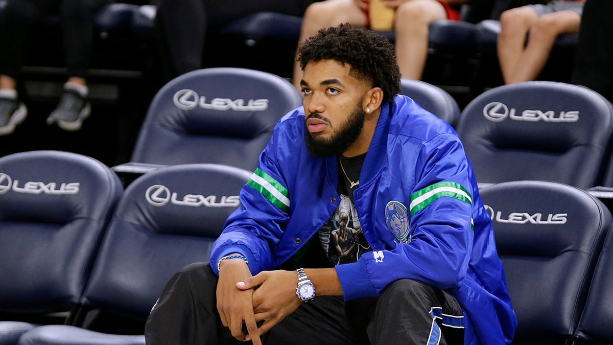Karl-Anthony Towns watches from seats during practice