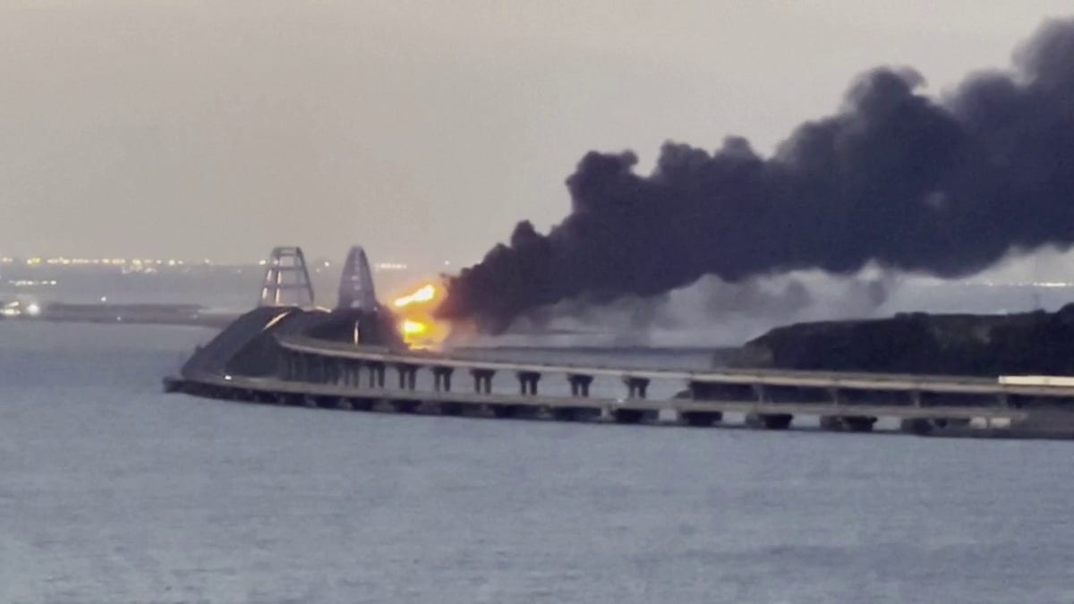 The Kerch Bridge with a pillar of black smoke