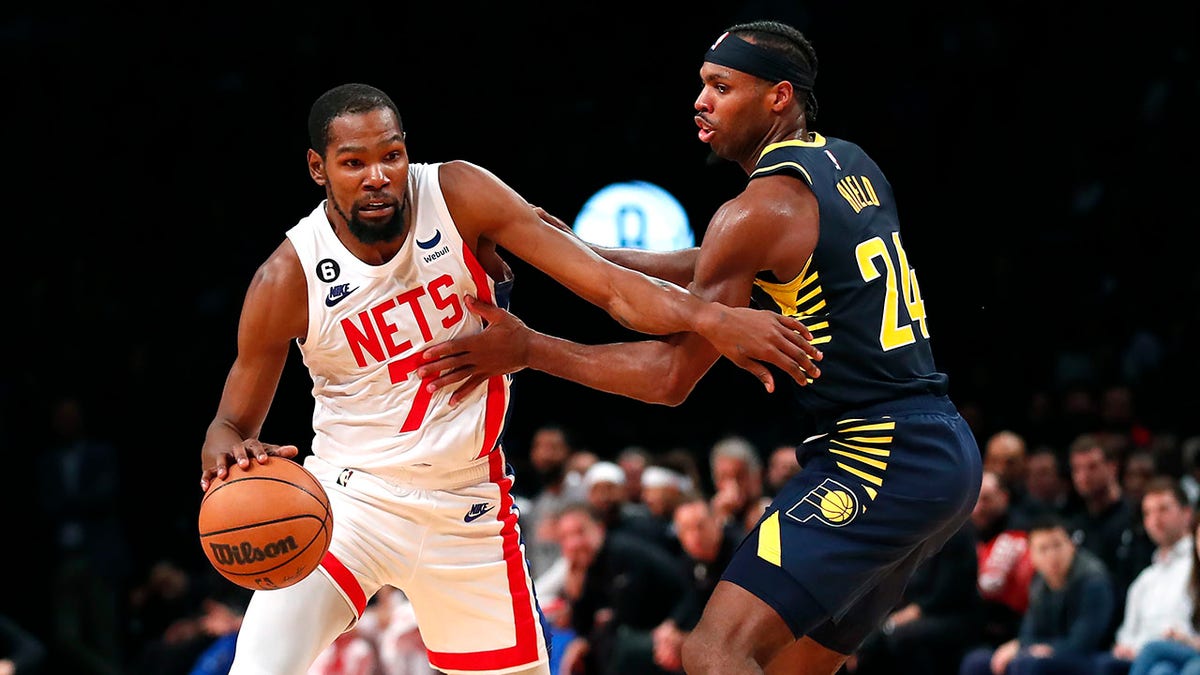 Kevin Durant drives past Buddy Hield