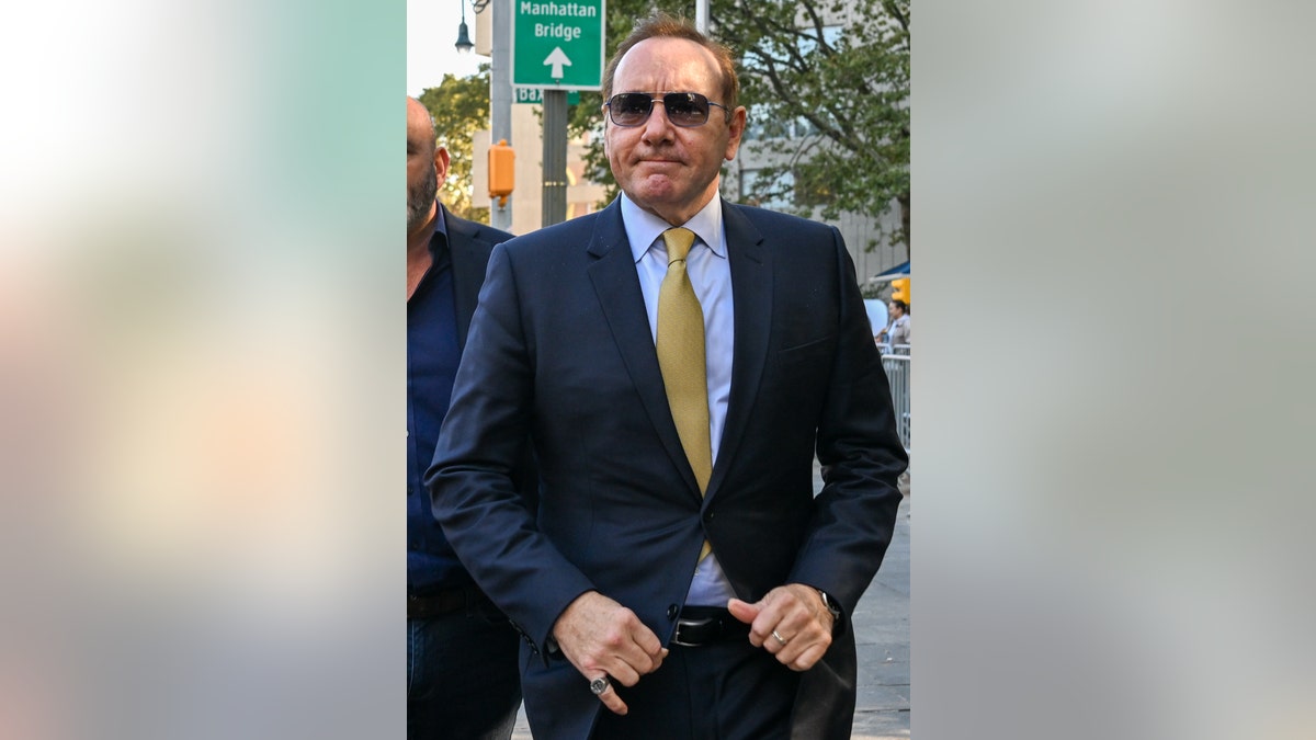 Kevin Spacey wears a blue suit and sunglasses in Manhattan