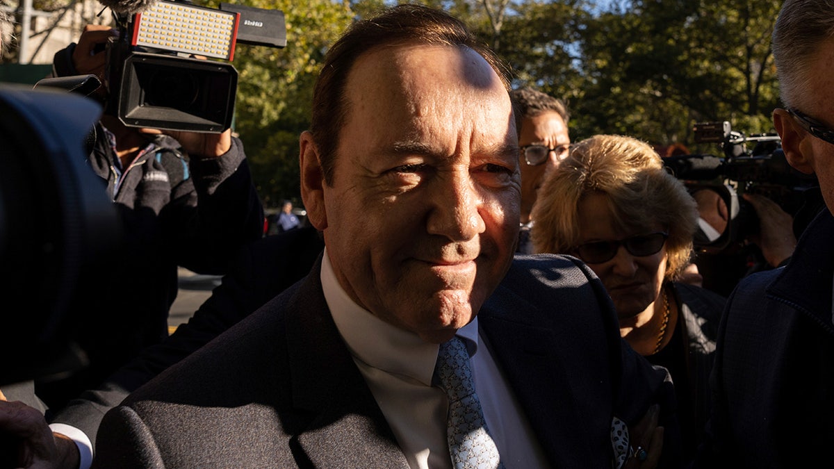 Kevin Spacey faces a scrum of reporters as he arrives for sex abuse trial in NYC