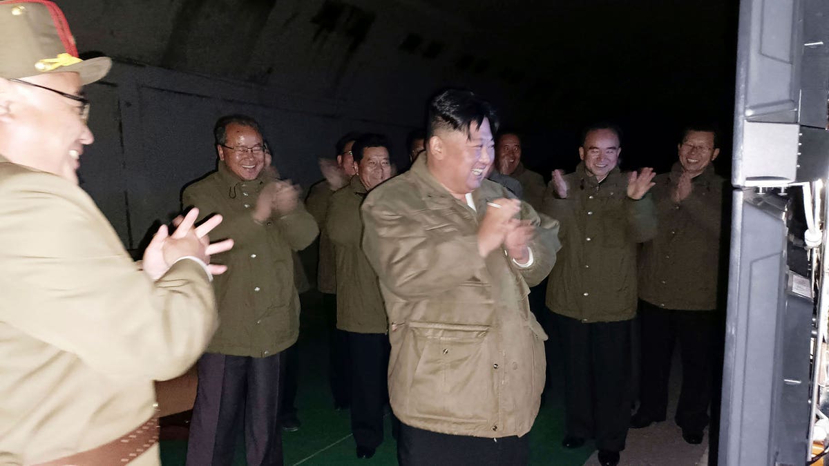 Kim Jong Un celebrating with other North Korean officials