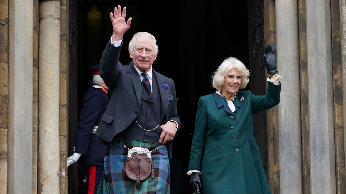 King Charles and Camilla wave