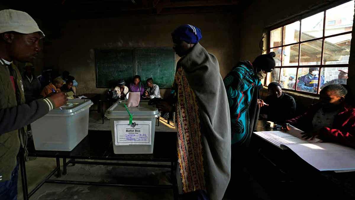 A man wearing a blanket cast his vote